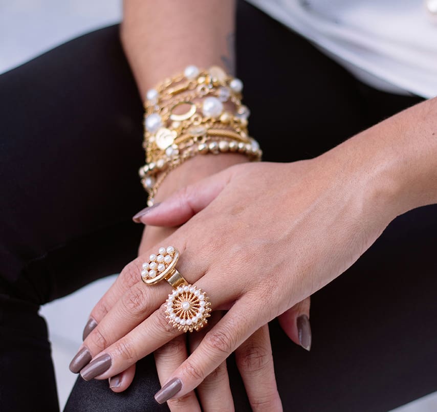 A woman 's hands with jewelry on her fingers.