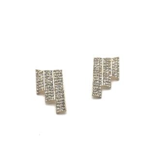 A pair of earrings with a pattern made out of letters.