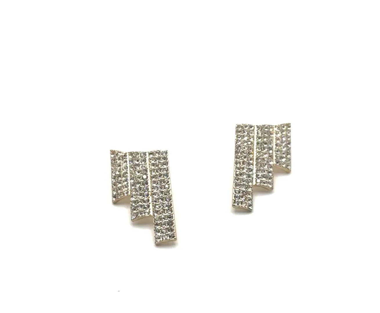 A pair of earrings with a pattern made out of letters.