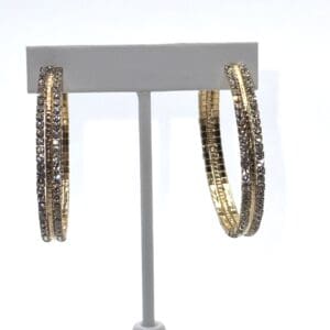A pair of gold hoop earrings with a white background
