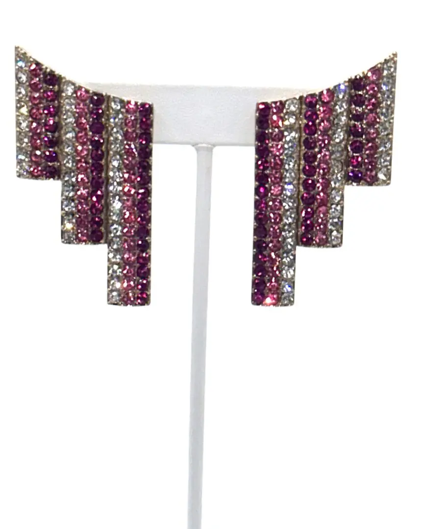 A pair of earrings with pink and silver rhinestones.