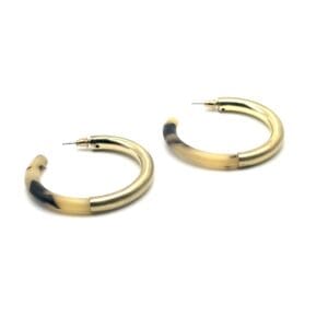 A pair of gold and black hoop earrings.