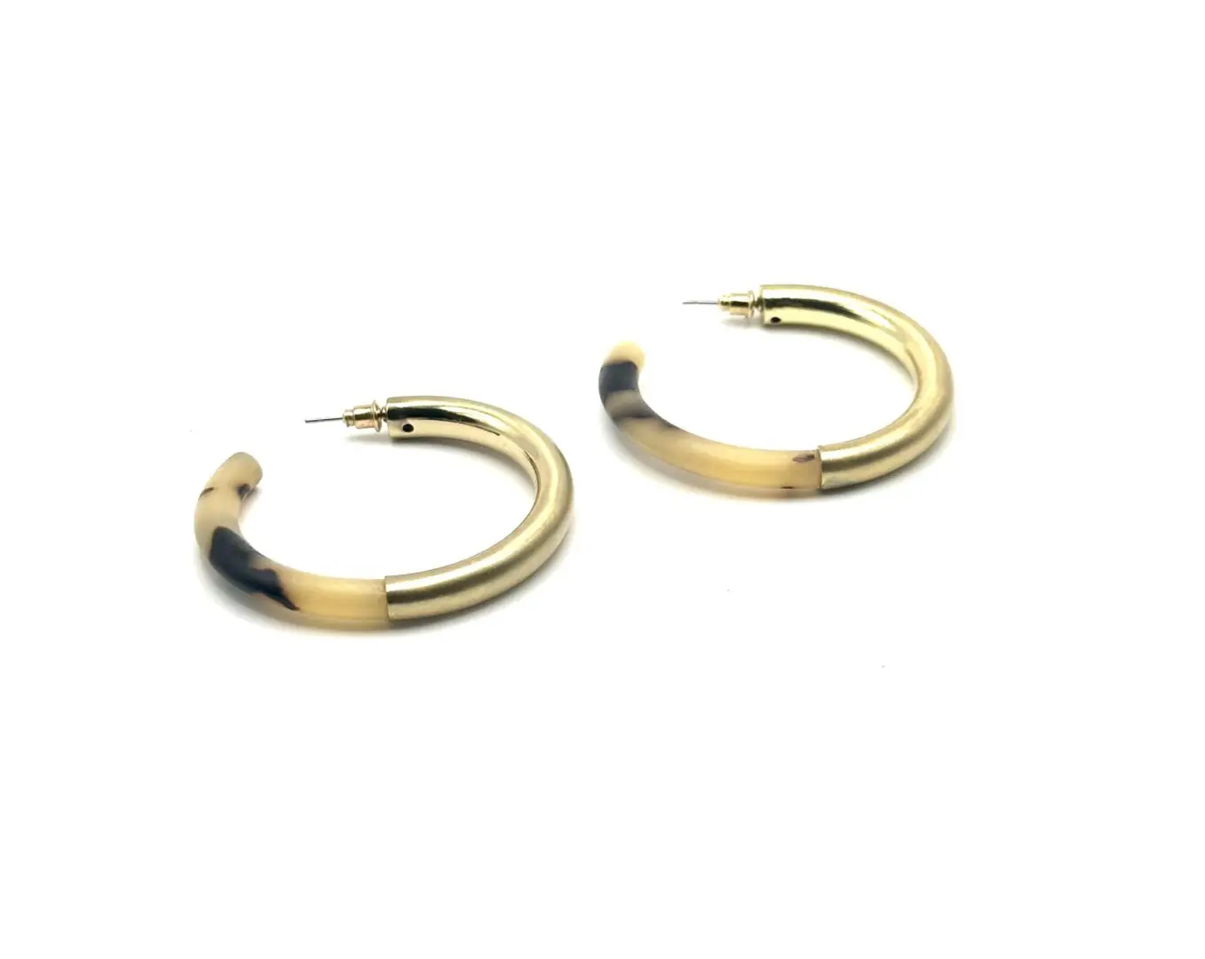 A pair of gold and black hoop earrings.