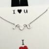 A necklace that says i love you with an image of a heart.