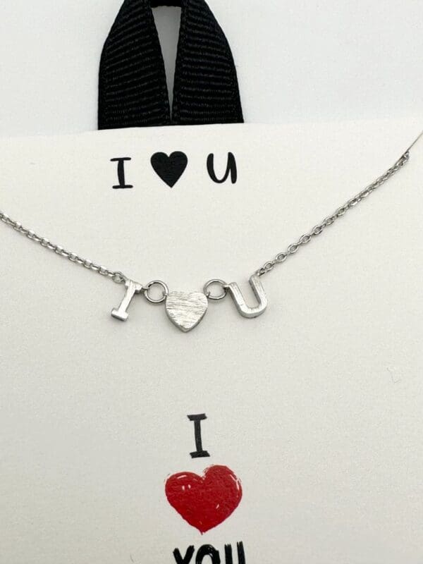 A necklace that says i love you with an image of a heart.